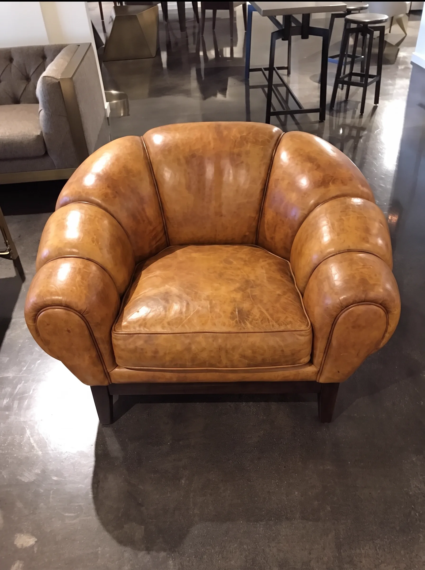Cracked, worn leather club chair before restoration